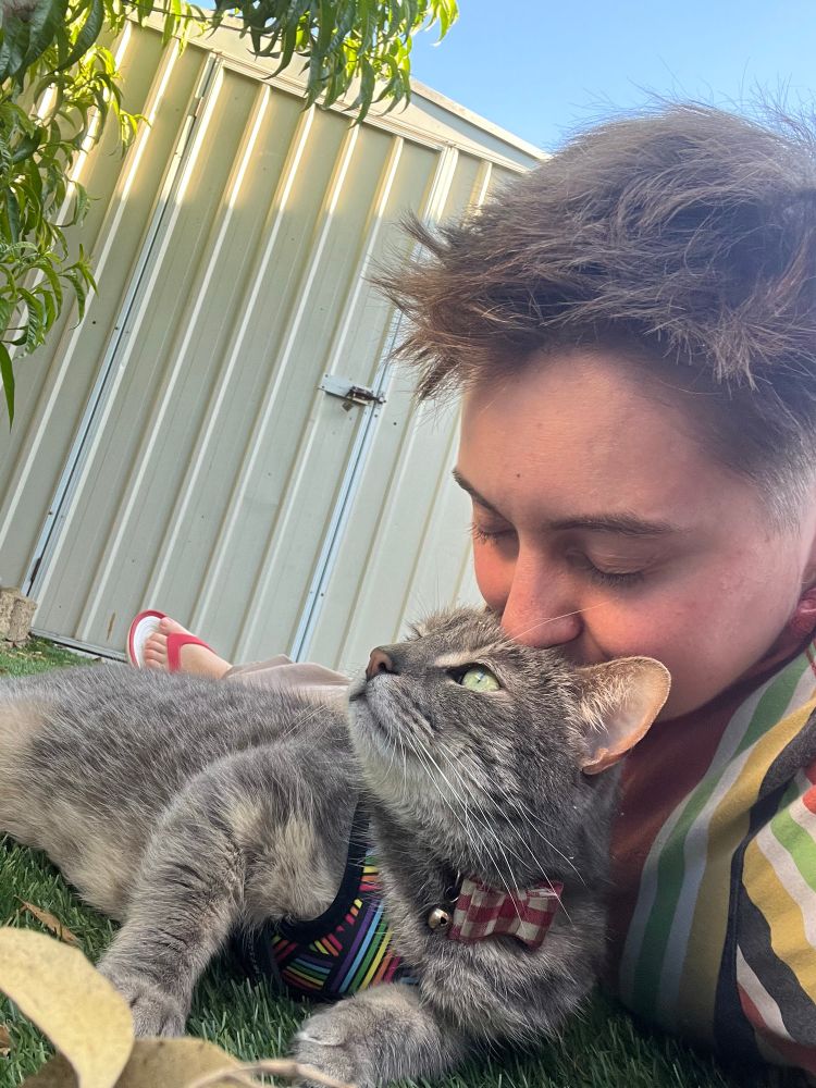 Me in the backyard with Leroy my cat giving him a kiss