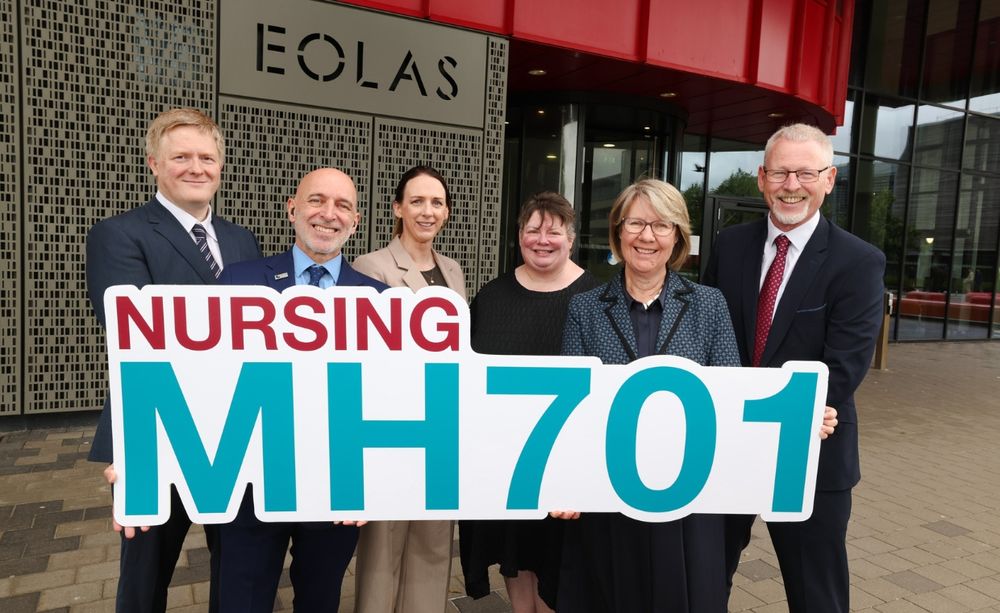 group of people outside holding a banner that says 'MH701 Nursing'