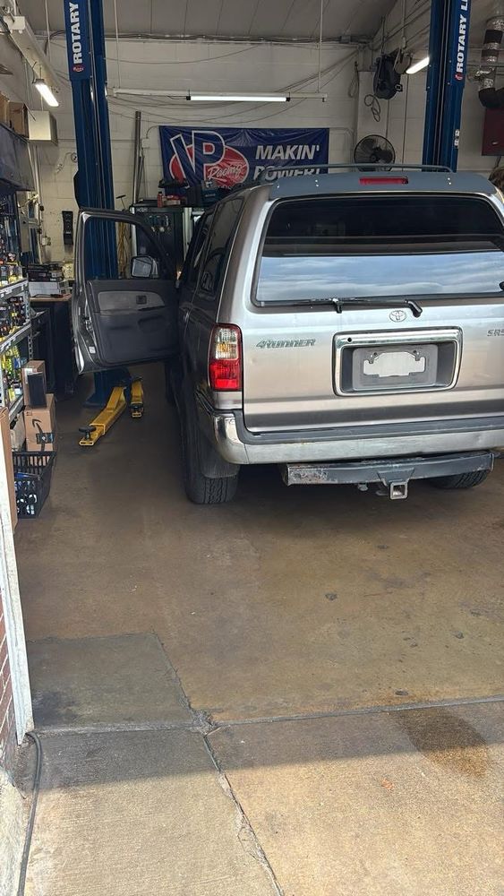 Silver 2002 Toyota 4Runner pulled into a bay at the mechanic’s to get inspected.