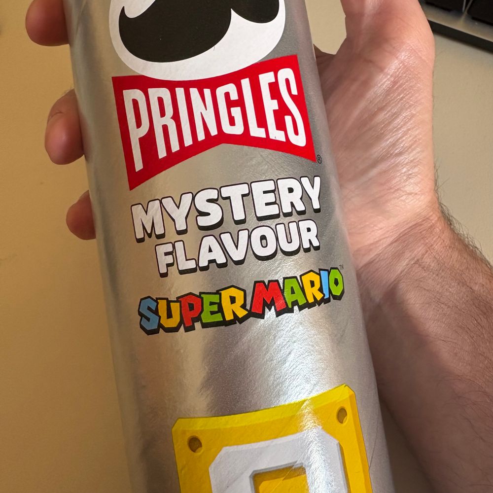 A silver tube of Pringles labelled ‘mystery flavour’ with the Super Mario logo and a question block.