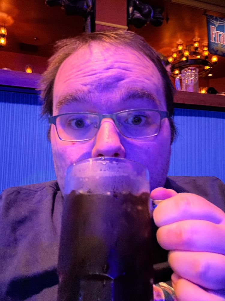 Surprised face when drinking out of a large mug.