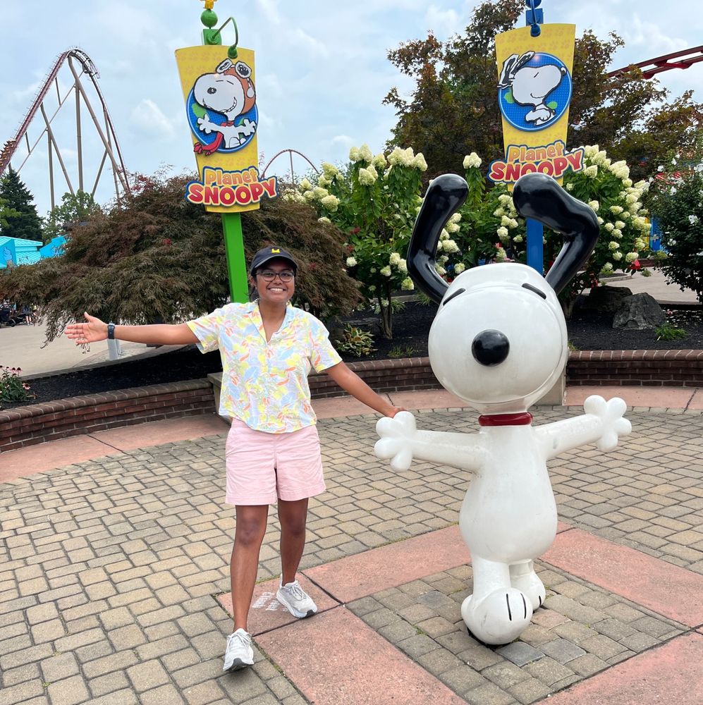 Me and SNOOPY at Planet Snoopy at King's Island. I'm dressed like a surfer and wearing a Pikachu hat.
