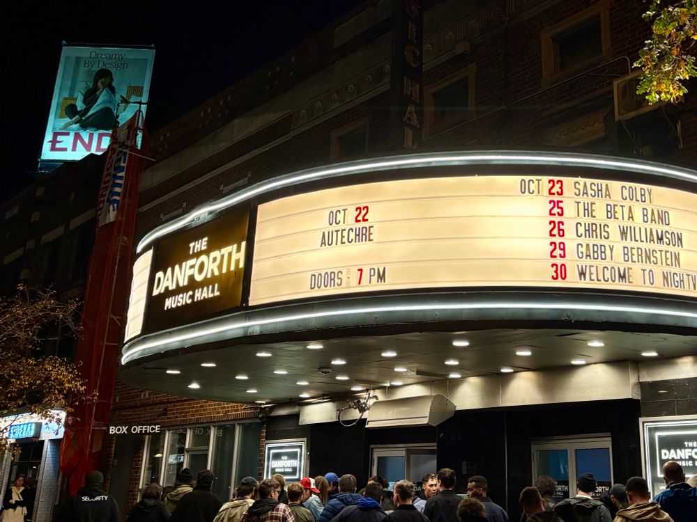 The marquee of The Danforth Music Hall in Toronto with the electronic music duo Autechre being tonight’s featured event. There are people in front of the music hall, in line waiting to get in.