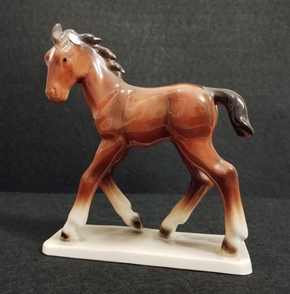 Brown glossy porcelain foal missing left ear