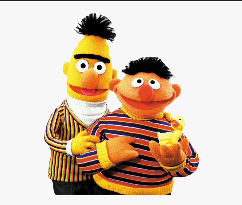 Bert and Ernie, holding Rubber Duckie.