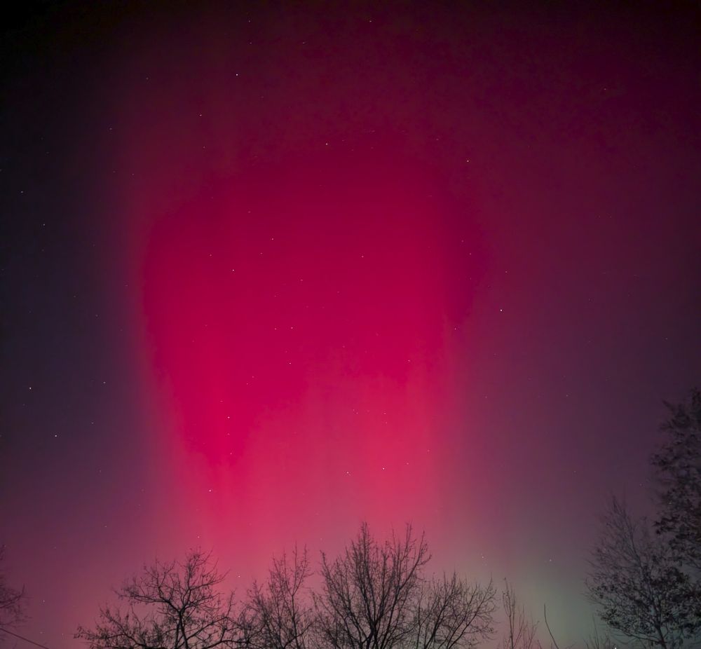 Bright scarlet sheets of light in the night sky.