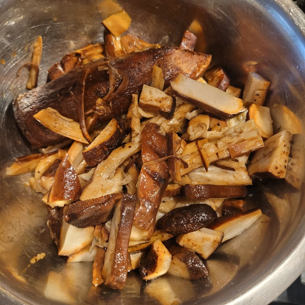 Shredded smoked mushrooms in a steel bowl