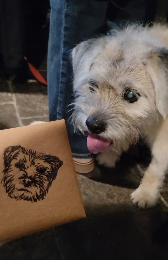 Handing over an envelope with a sketch of the birthday dog on it to the dog of honor. 