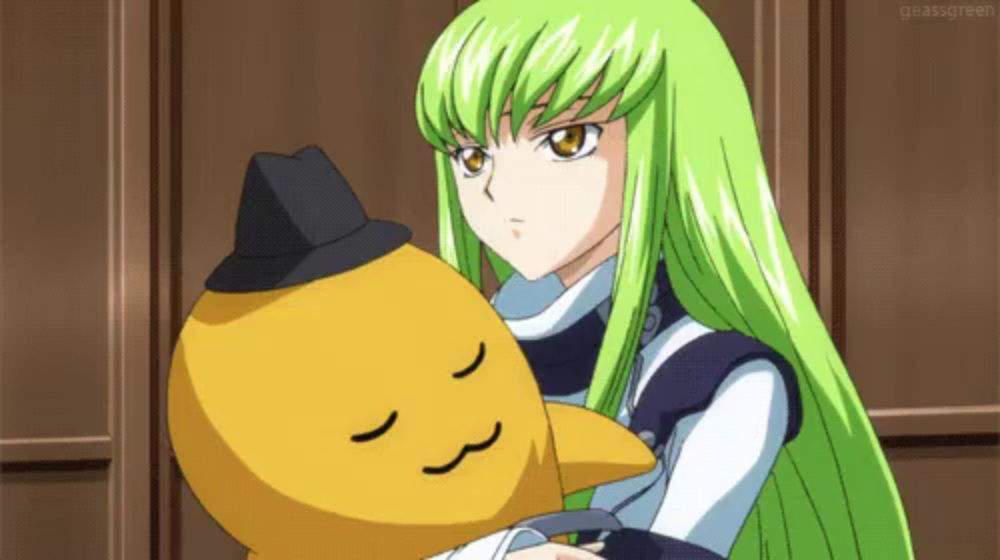 a girl with green hair is holding a stuffed animal with a hat on it