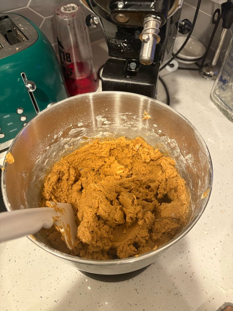 Light brown gingerbread dough in a mixing bowl.