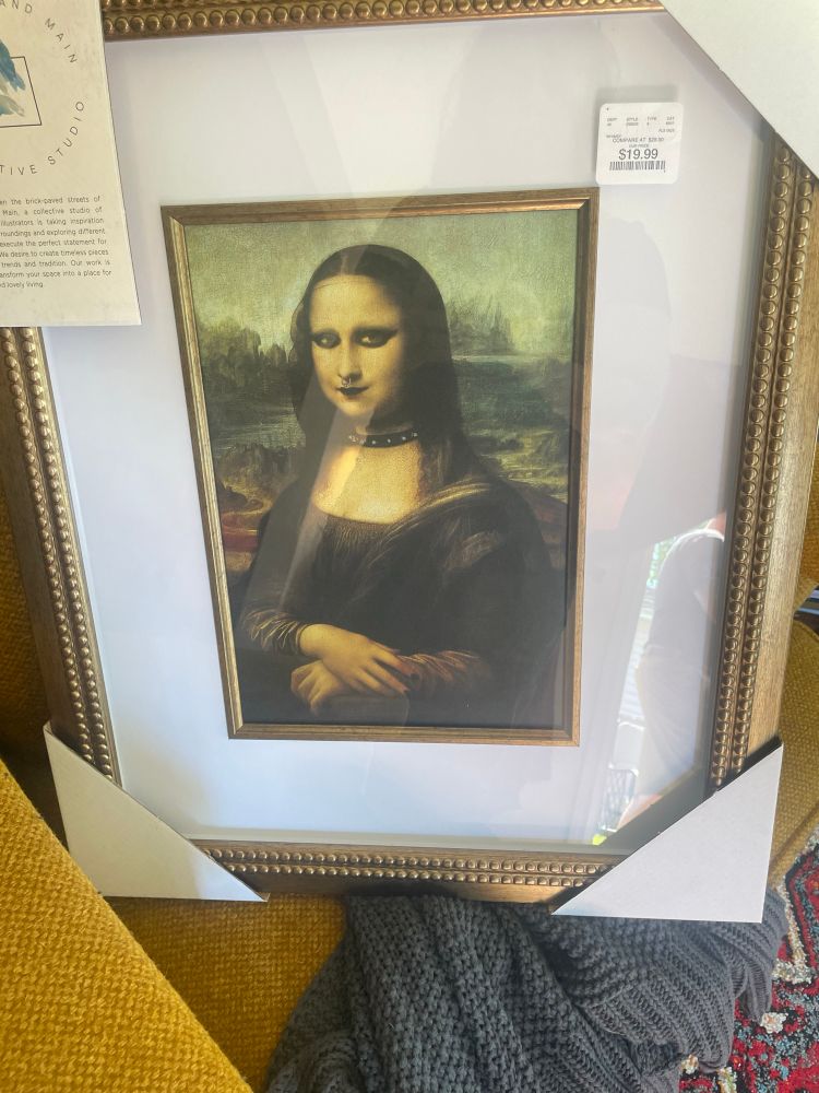 A framed print of the Mona Lisa with a septum ring, gothic makeup, and a choker.