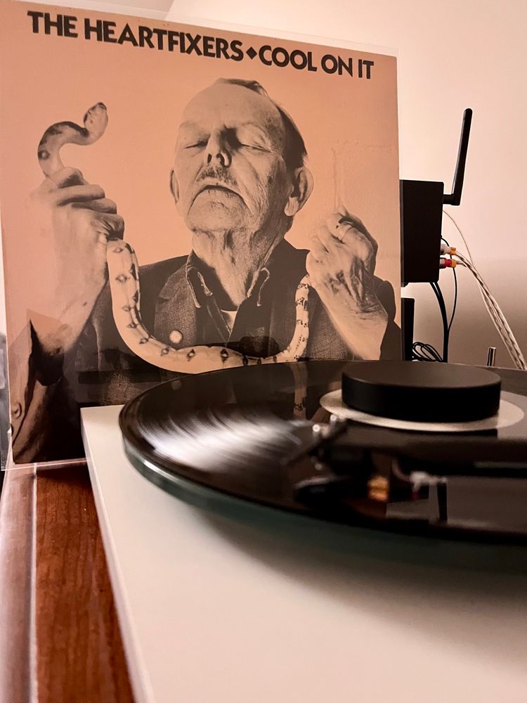 The album cover shows an older Caucasian man with his head back and eyes closed. He’s holding a snake in a religious ceremony. His name is Reverend Forrest Kerns. 