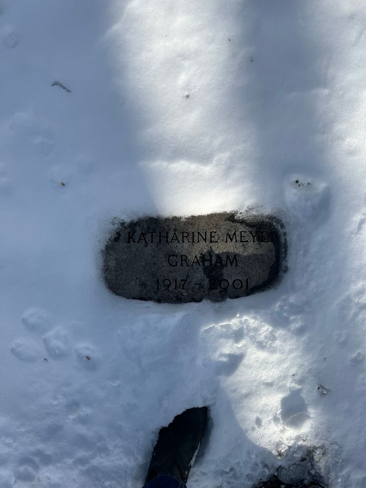 Katharine Graham’s simple, flat gravestone in Oak Hill Cemetery in Georgetown (a neighborhood in Washington, DC).