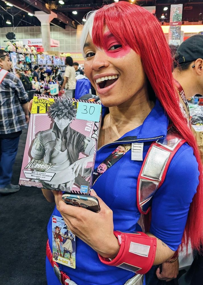 Me cosplaying as Shoto holding a Dabi figure 