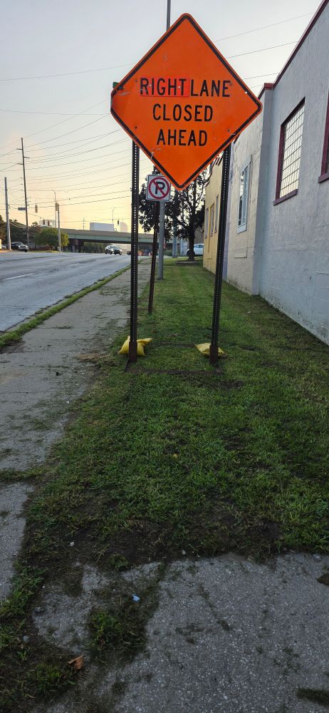 The sign is once again moved onto the grass, completely out of the sidewalk.