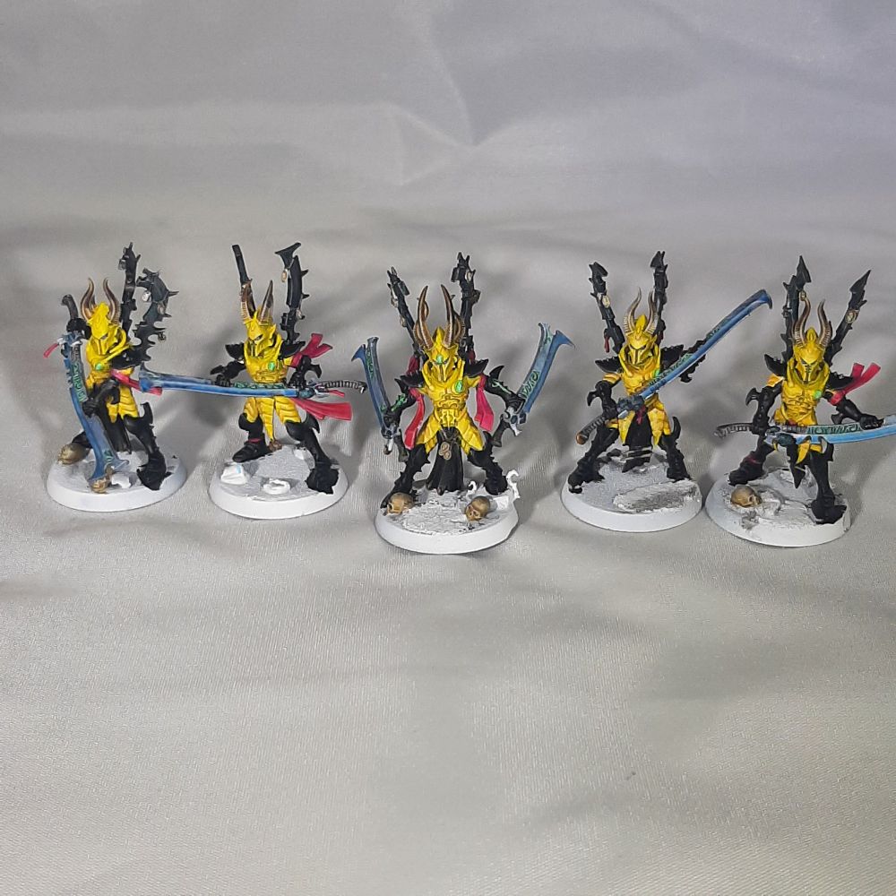 Drukari Incubi models painted in yellow and black, with Magenta tassels, blue power sword blades, and Hexwraith Flame green gem and Rune details