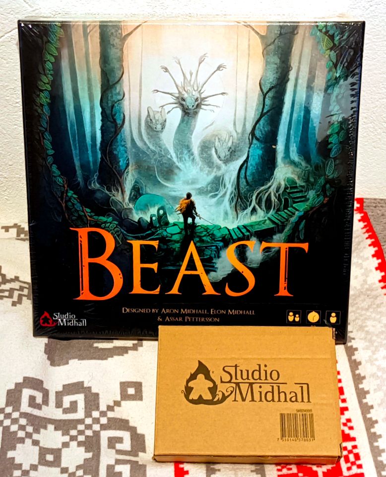 Beast boardgame (hydra, forest, and sword-wielding hunter on the cover), along with a small package of acrylic standee figures for the game.