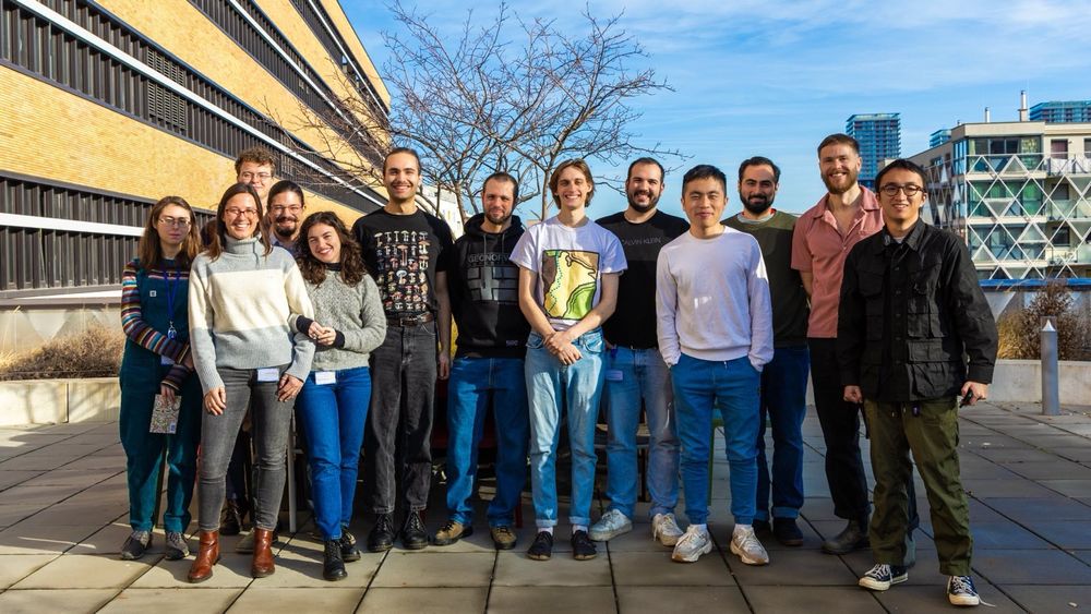 group photo of the fungal ecology lab standing outside on a sunny day
