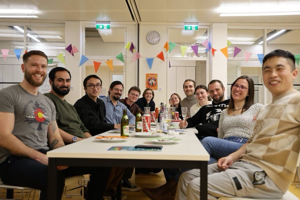 The lab group sitting a table smiling 