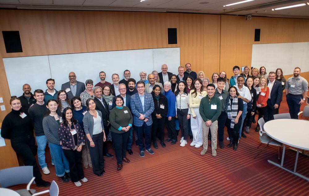 A group of people stand together in a room