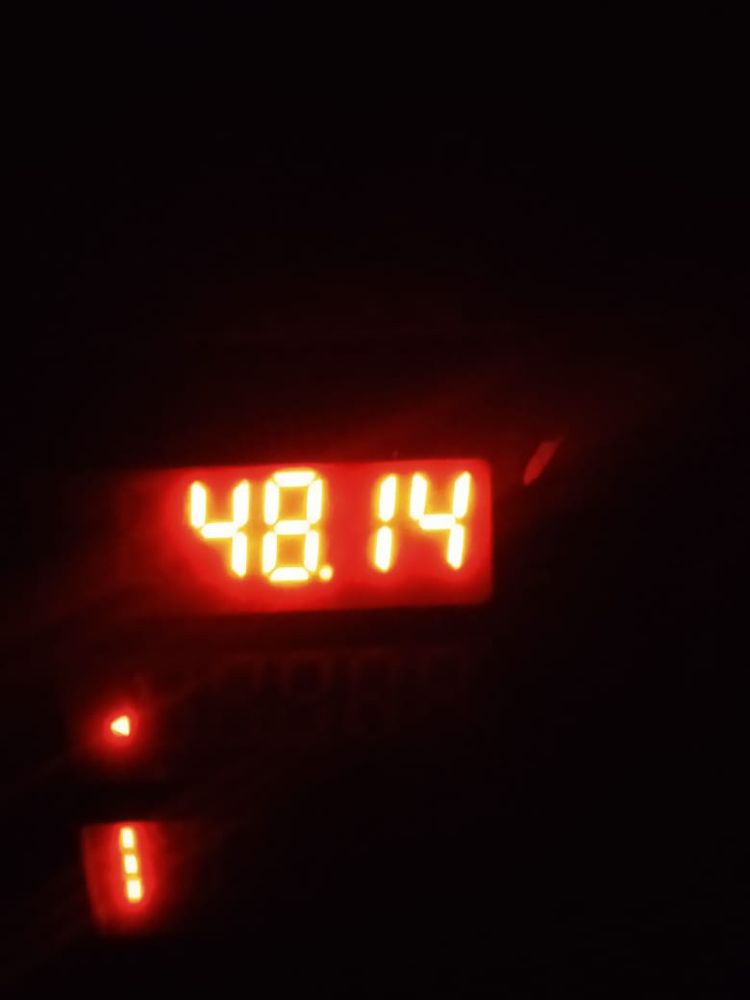 A scale showing a weight of 48.14 kilos