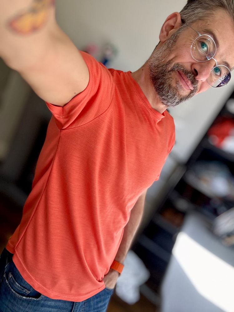 A man wearing a handmade t-shirt, orange