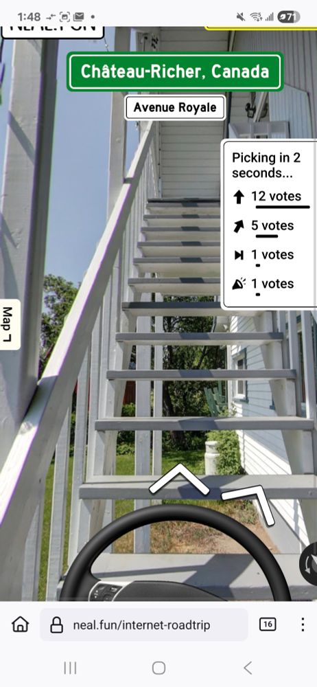 The car steering wheel superimposed onto an image of white stairs leading up the side of a house