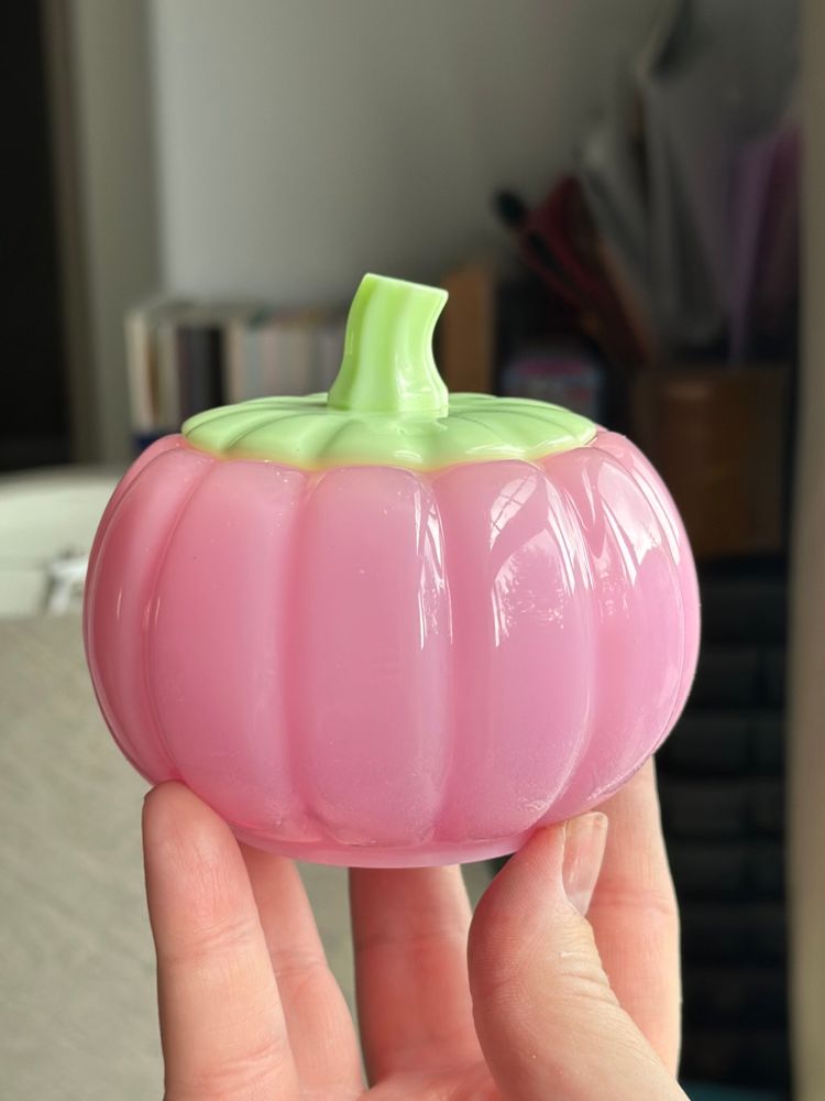 Pink resin pumpkin jar with a neon green lid