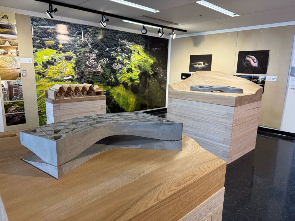 Gallery photos of Zhang Ke’s exhibit, Earth-Dwelling, at the UVA School of Architecture featuring three models on monolithic wood bases 
