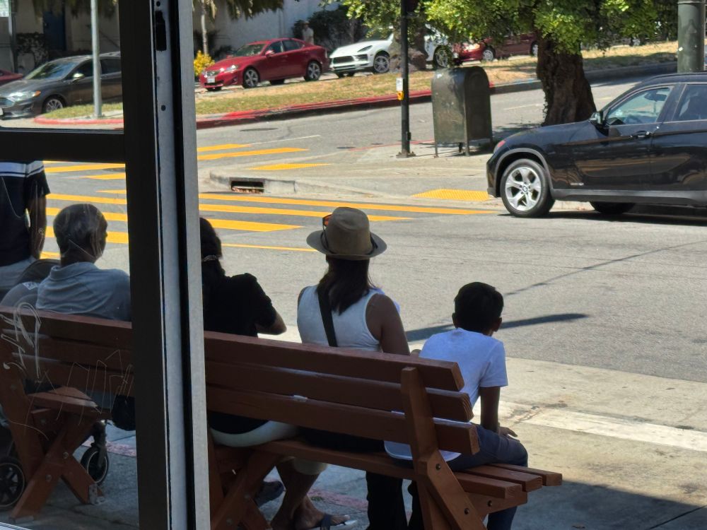 Family taking a shade break in the heat yesterday, thanks to bench installed by locals 