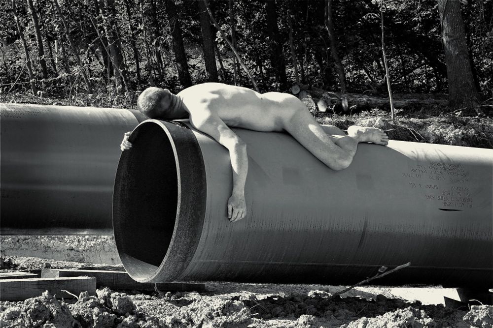 My laying face down naked on a new gas pipe.