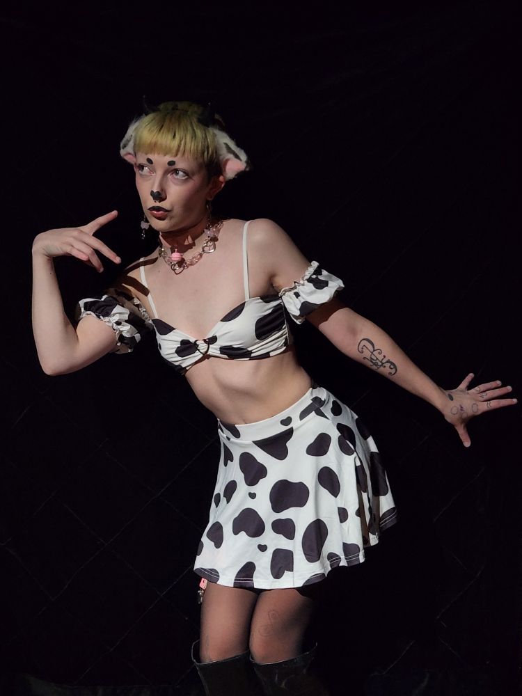 Emmy in his cow Moeflavor set, posing all gay