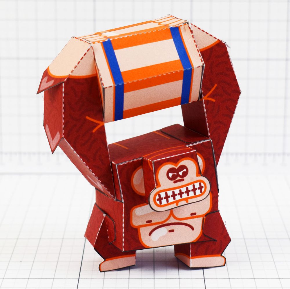 a photo of a papercraft depicting a large ape throwing a barrel 
