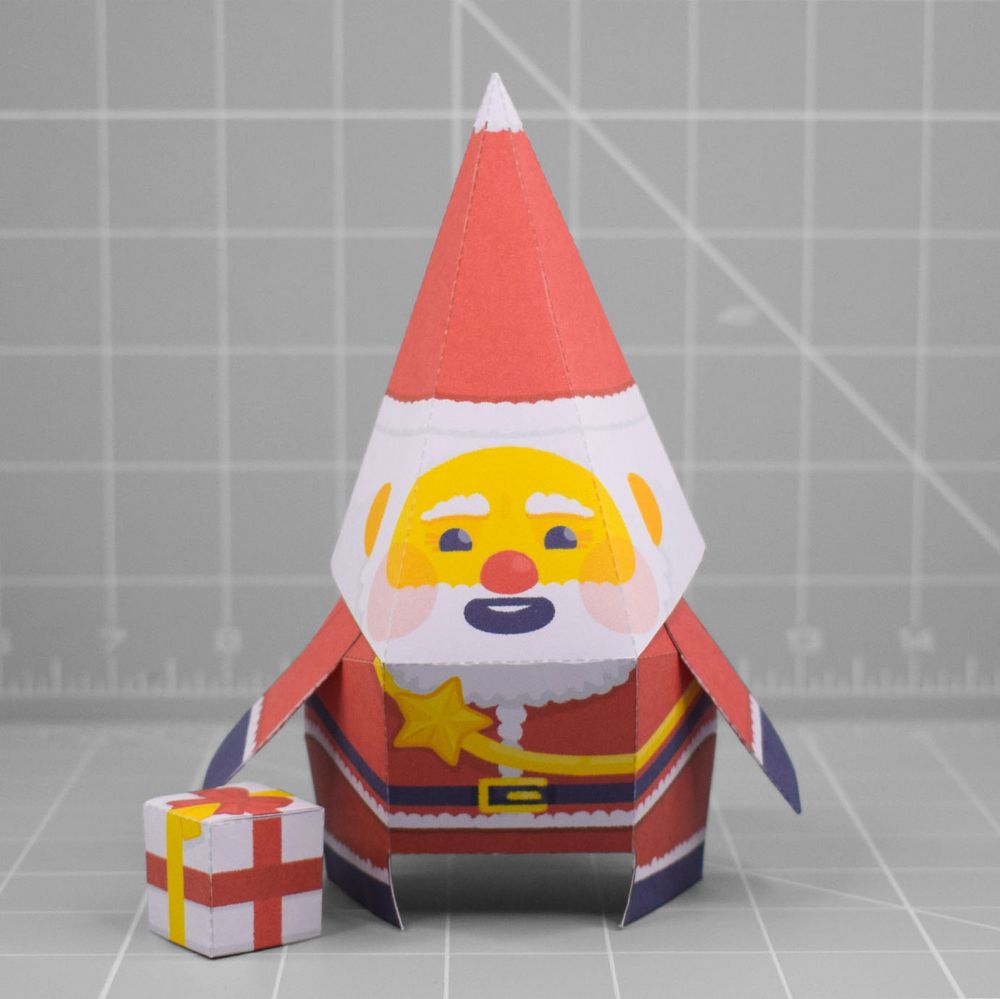 A photo of a papercraft depicting a cheeky looking Santa with yellow skin. 