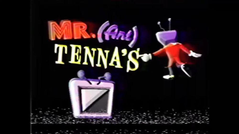 A cap from Tenna's introduction showing him pointing at his own logo, of his own head, split on the diagonal like the prophecy