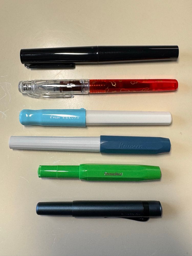 Various inexpensive fountain pens - capped. 