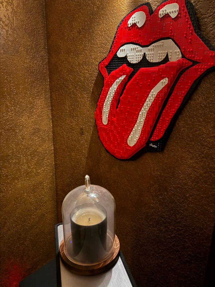 Smoking candle with the Rolling Stones logo in Lego on the wall