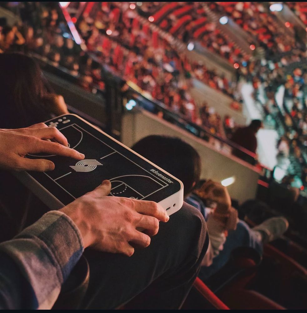 Fan holding device that allows user to feel real time haptics at Blazers basketball arena 