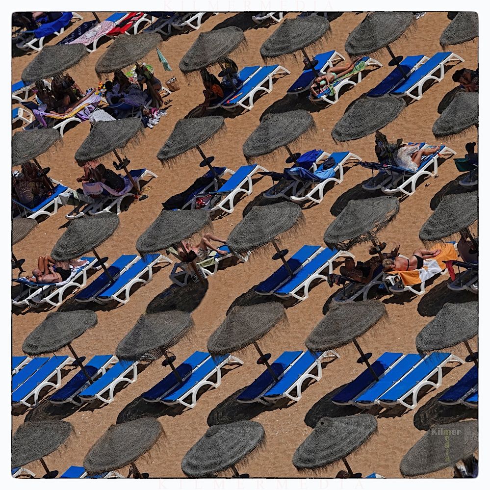 Umbrellas and sun loungers are shown on a beach in Albufeira, Portugal.