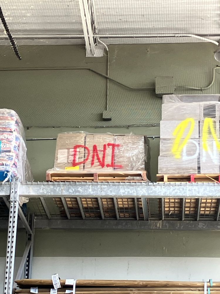 Boxes on a shelf wrapped up and labelled "DNI"