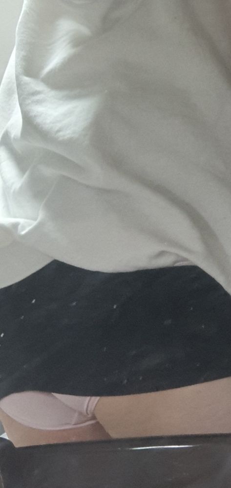 Jun in her white hoodies, white thigh highs, and a black pencil skirt. Her skirt's riding up, revealing her pink panties.