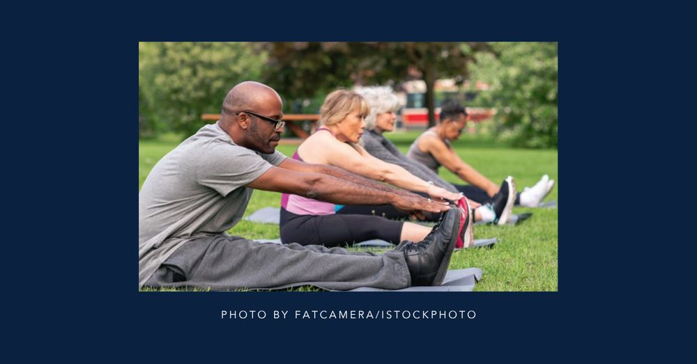 A group of people stretching together in the park.