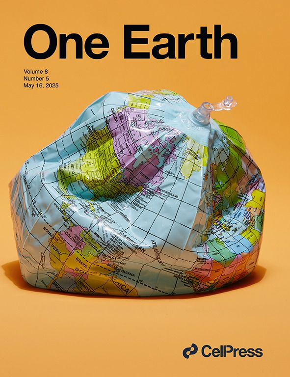 One Earth May cover: a deflating blow-up globe made of plastic against an orange background.