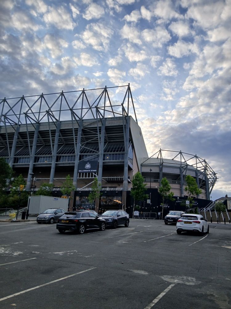 St James's Park from the corner of the gallowgate end and east stand. The sky is full of clouds that look like cotton wool. The sun is going down