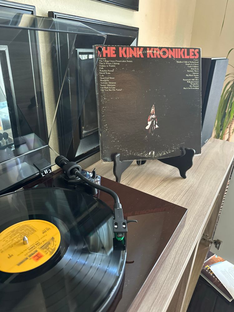 The Kink Kronikles black vinyl record on a brown turntable 