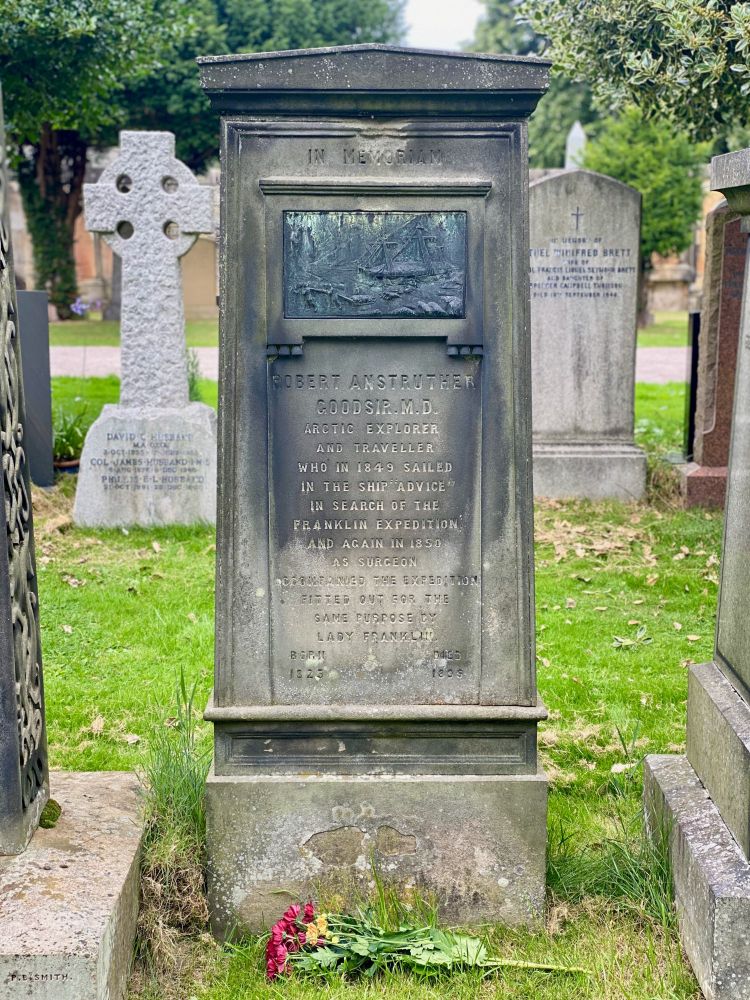 Image shows a very goth gravestone. There is a bronze bas relief of sail ships in an icy landscape near the top. The inscription reads:

Robert Anstruther Goodsir M.D.
Arctic explorer and traveller who in 1849 sailed in the ship "Advice" in search of the Franklin Expedition and again in 1850 as surgeon accompanied the expedition fitted out for the same purpose by Lady Franklin.

Born 1823
Died 1895 

The grave is located in Dean Cemetery in Edinburgh.