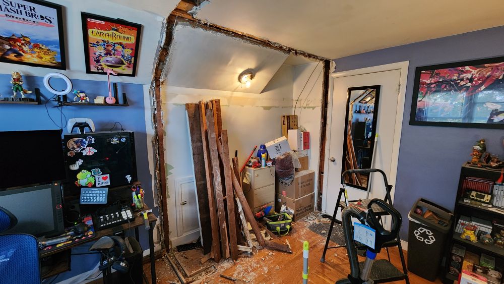 The wood framing of the closet has been completely removed with the wood lying against the wall.