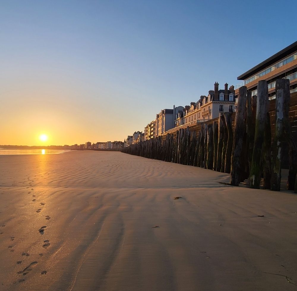 A sunrise over a beach.