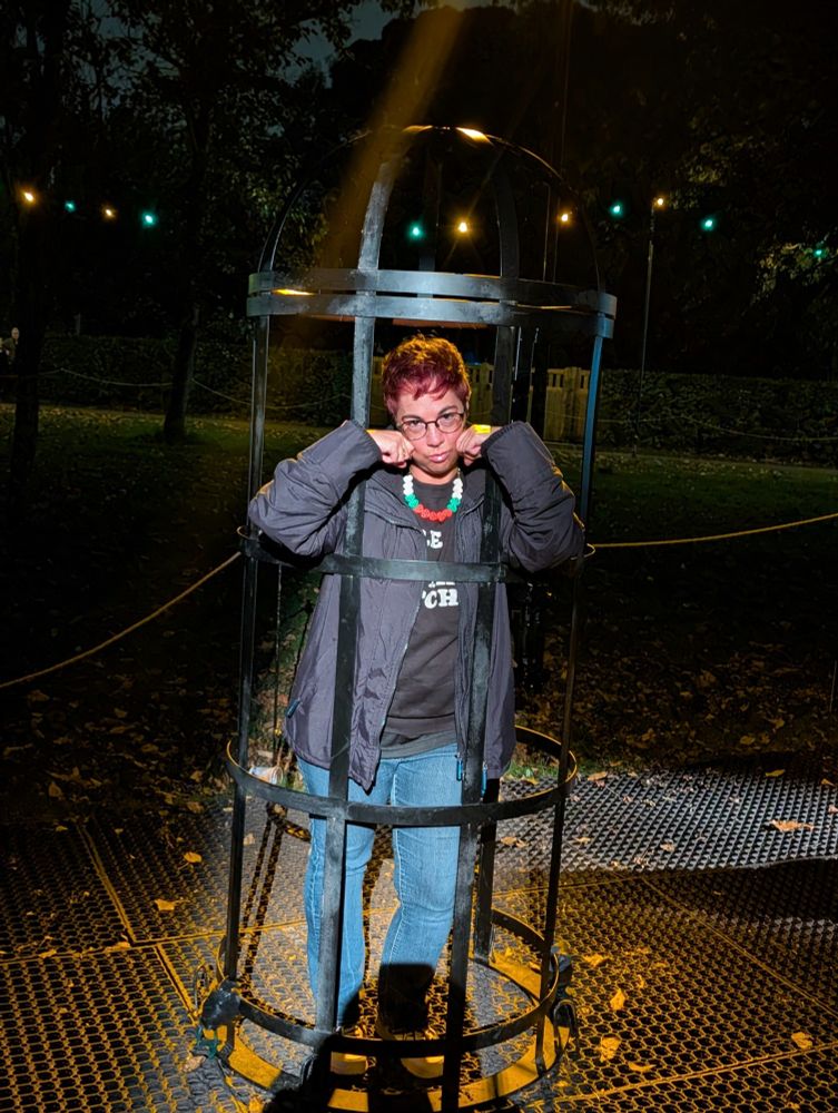 Person in a cage making a "sorry" face