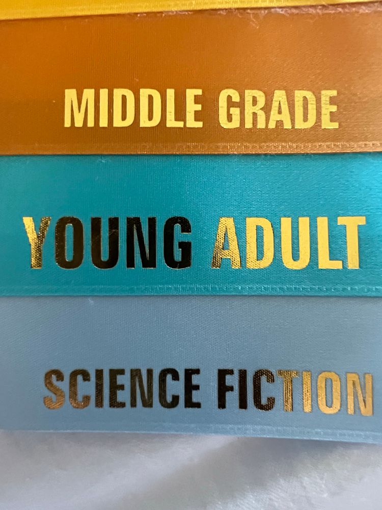 Ribbons with Middle Grade, Young Adult, and Science Fiction written on them.